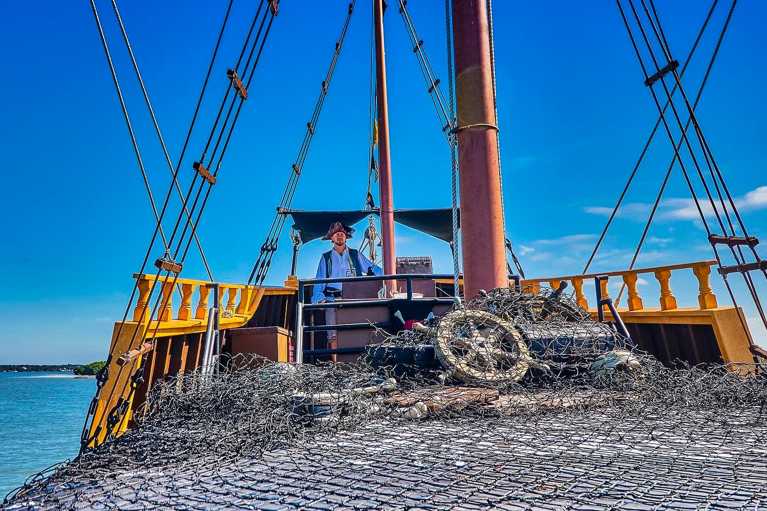 Tall ship deck and rigging on bright open-water sailing tour