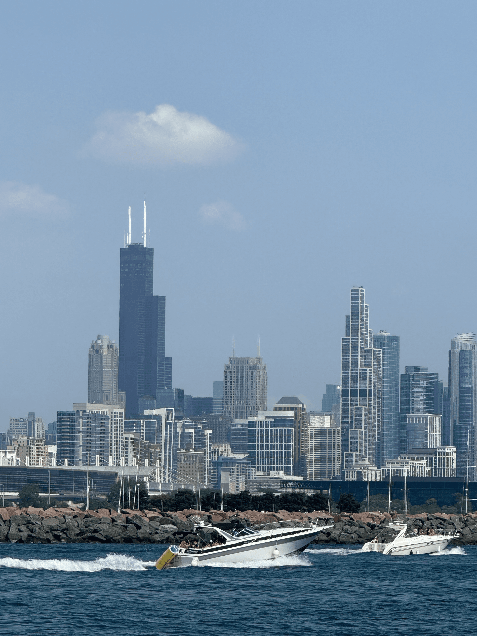 Speedboats near Chicago skyline along Lake Michigan shore