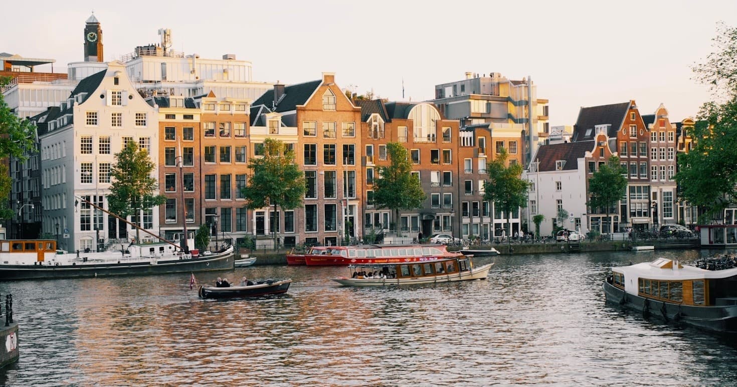 Historic canal-front row houses in Amsterdam for scenic waterfront strolls