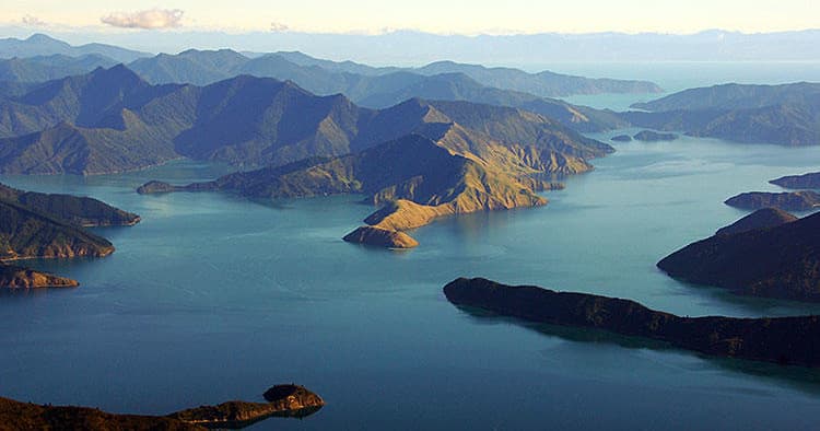 Aerial scenic flight over coastal bays and mountain islands