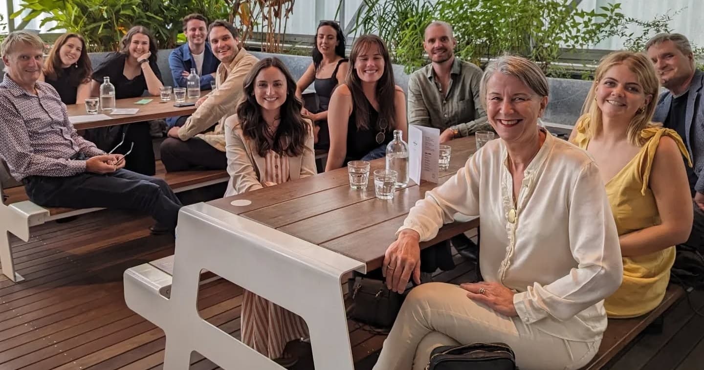 Large group dining on outdoor restaurant terrace celebrating together