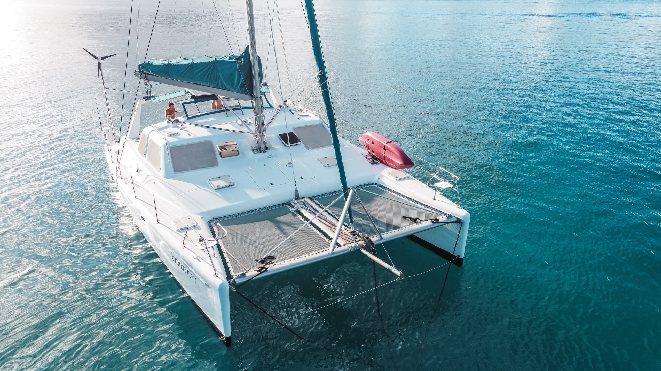 Aerial catamaran on turquoise ocean waters, deck details