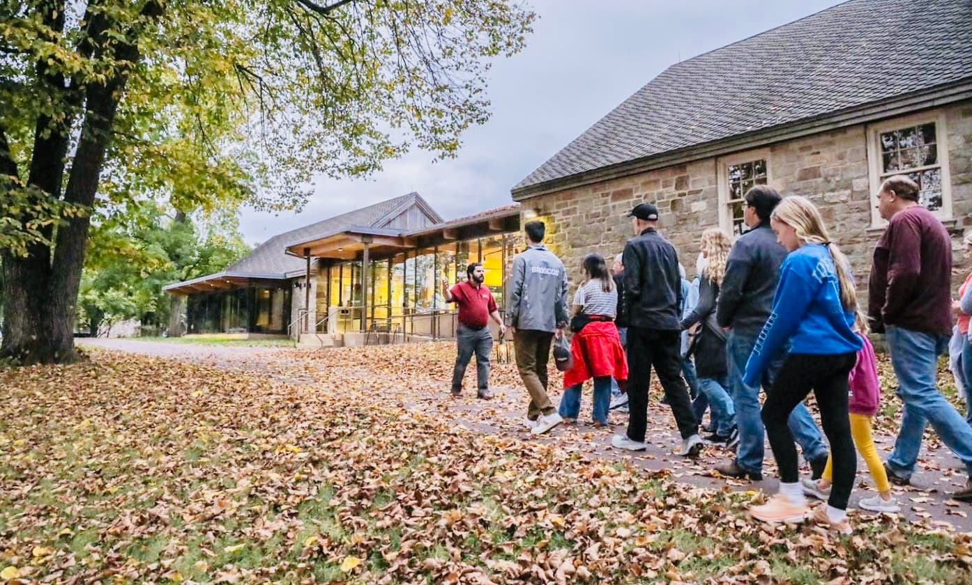 Guided fall walking tour along leaf-strewn park path