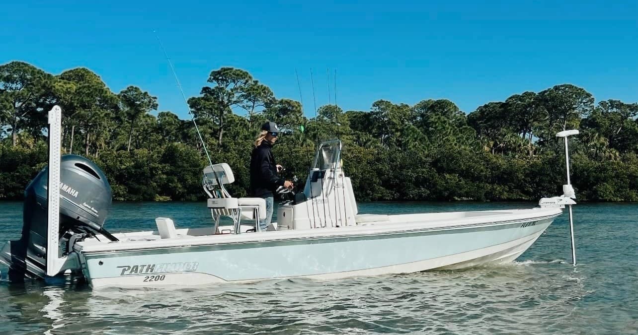 Center console fishing boat cruising shallow inshore waters