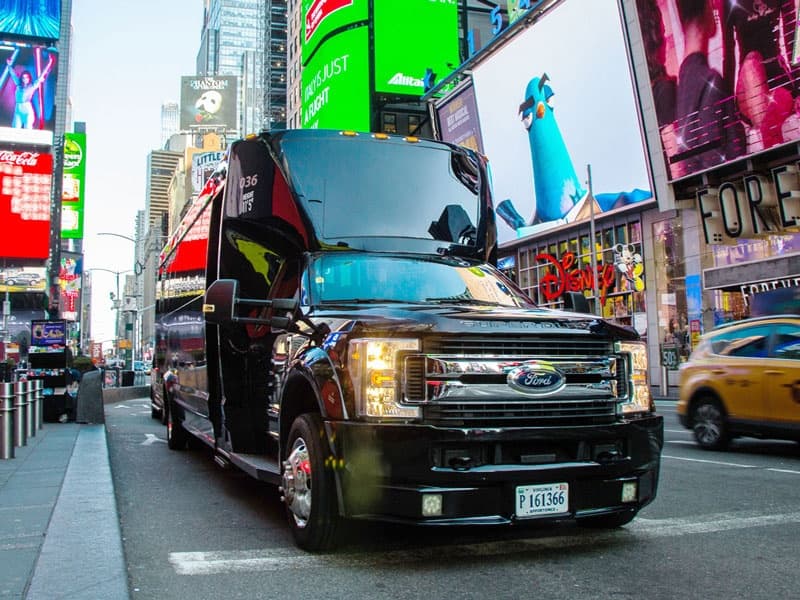 Executive group shuttle driving through Midtown Manhattan streets