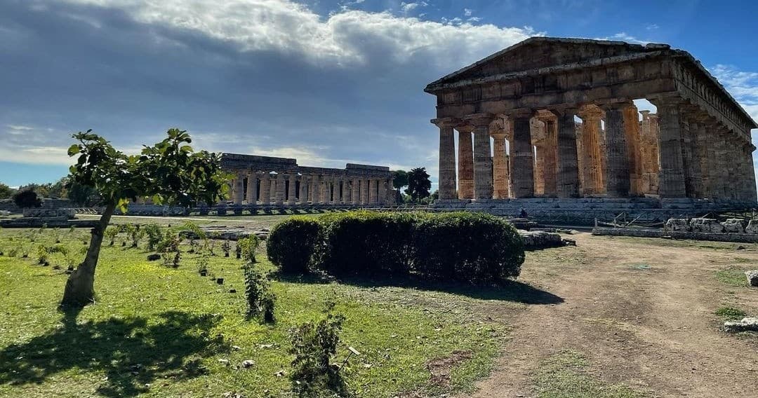 Temple ruins in open field in Paestum, Italy for sightseeing
