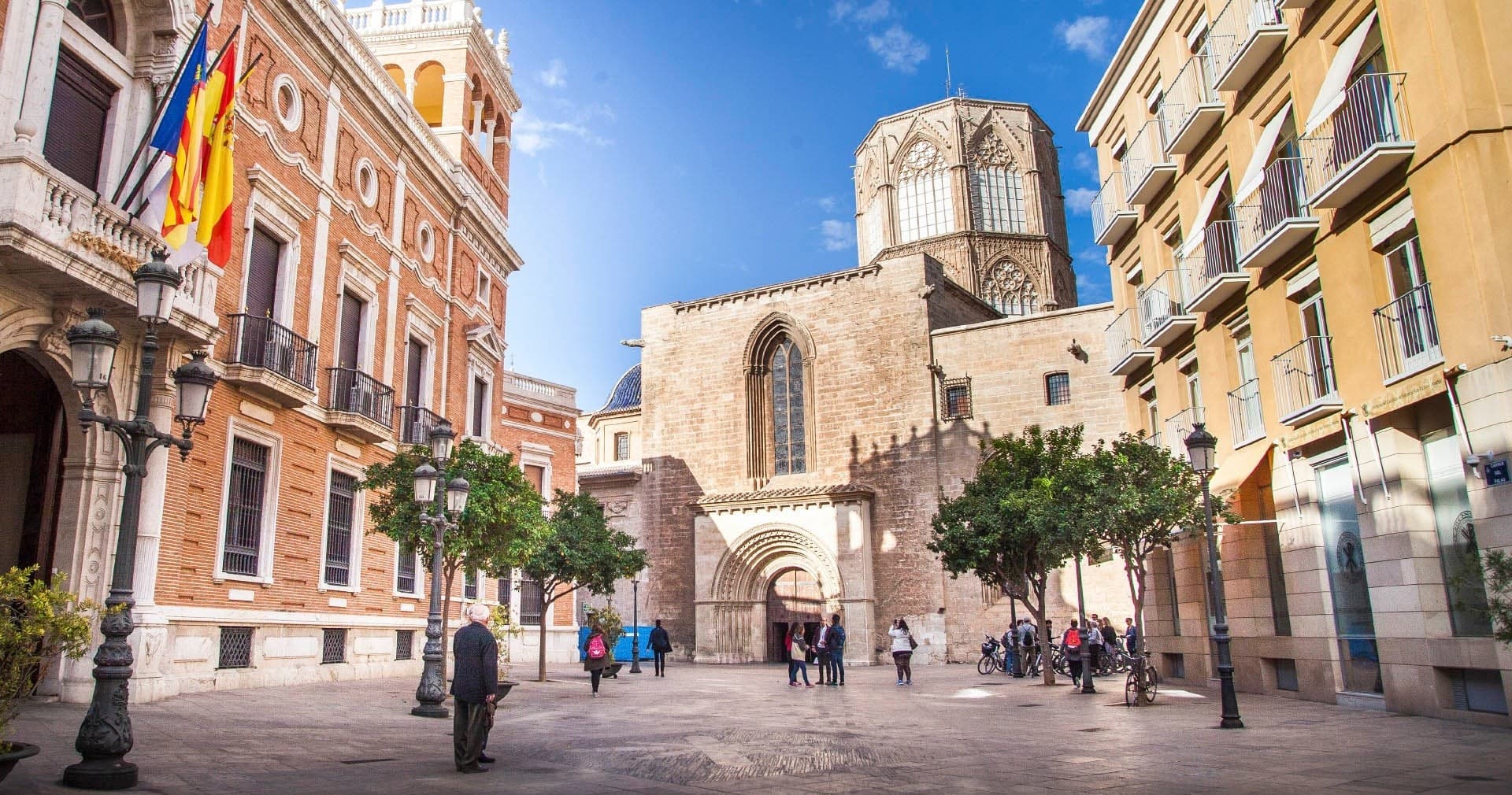 Historic Valencia plaza with pedestrians exploring cathedral square