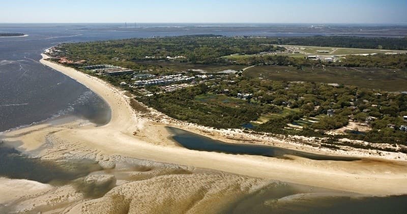 Coastal peninsula and long sandy beach from aerial perspective