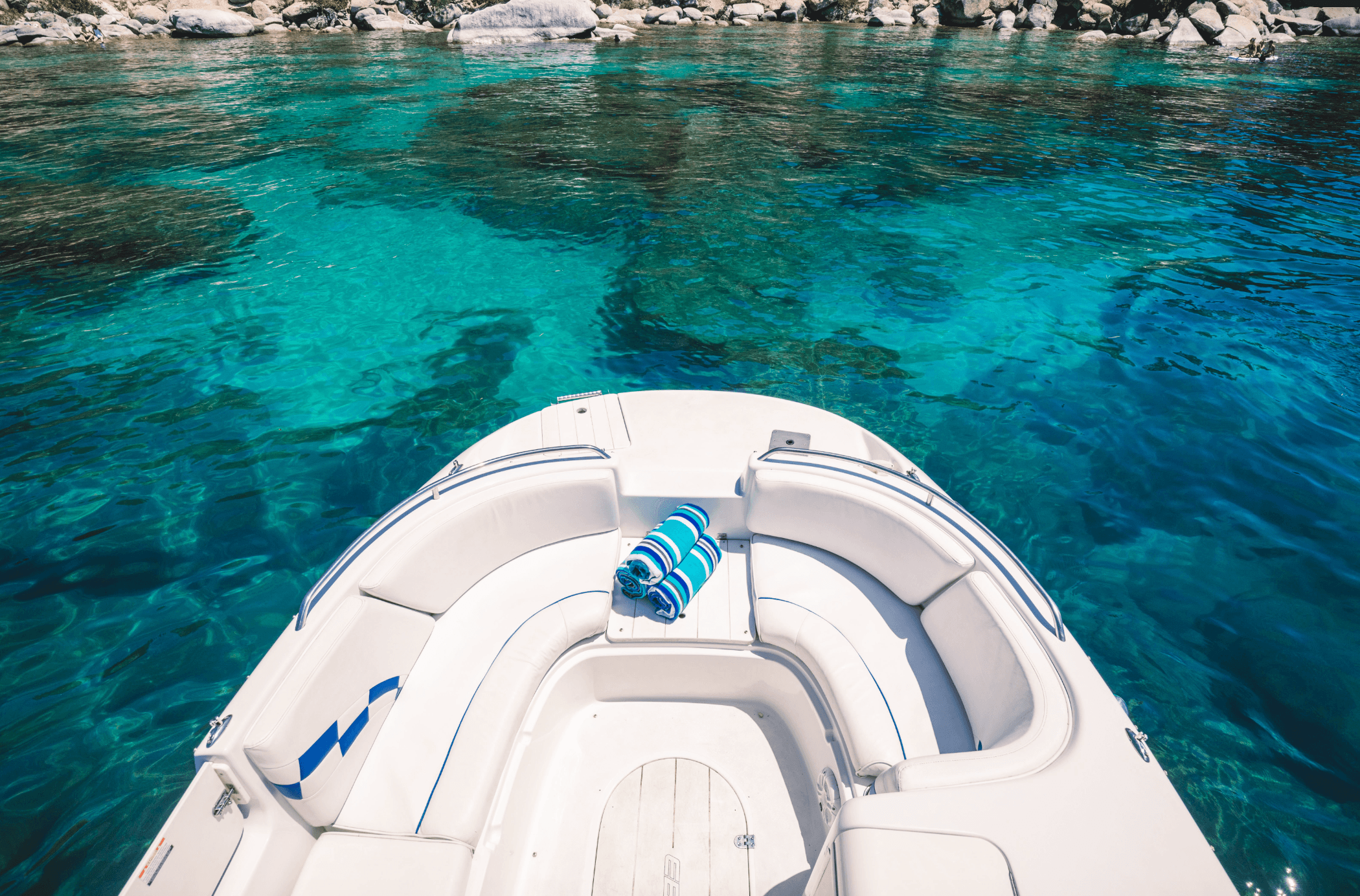 Boat bow cruising over crystal-clear Lake Tahoe waters