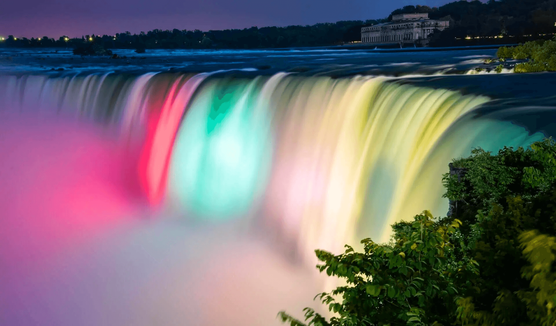 Long exposure Niagara Falls at night showcasing rainbow illumination