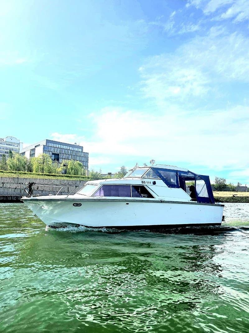 Docked white riverboat on the Rhine in Basel, calm waters