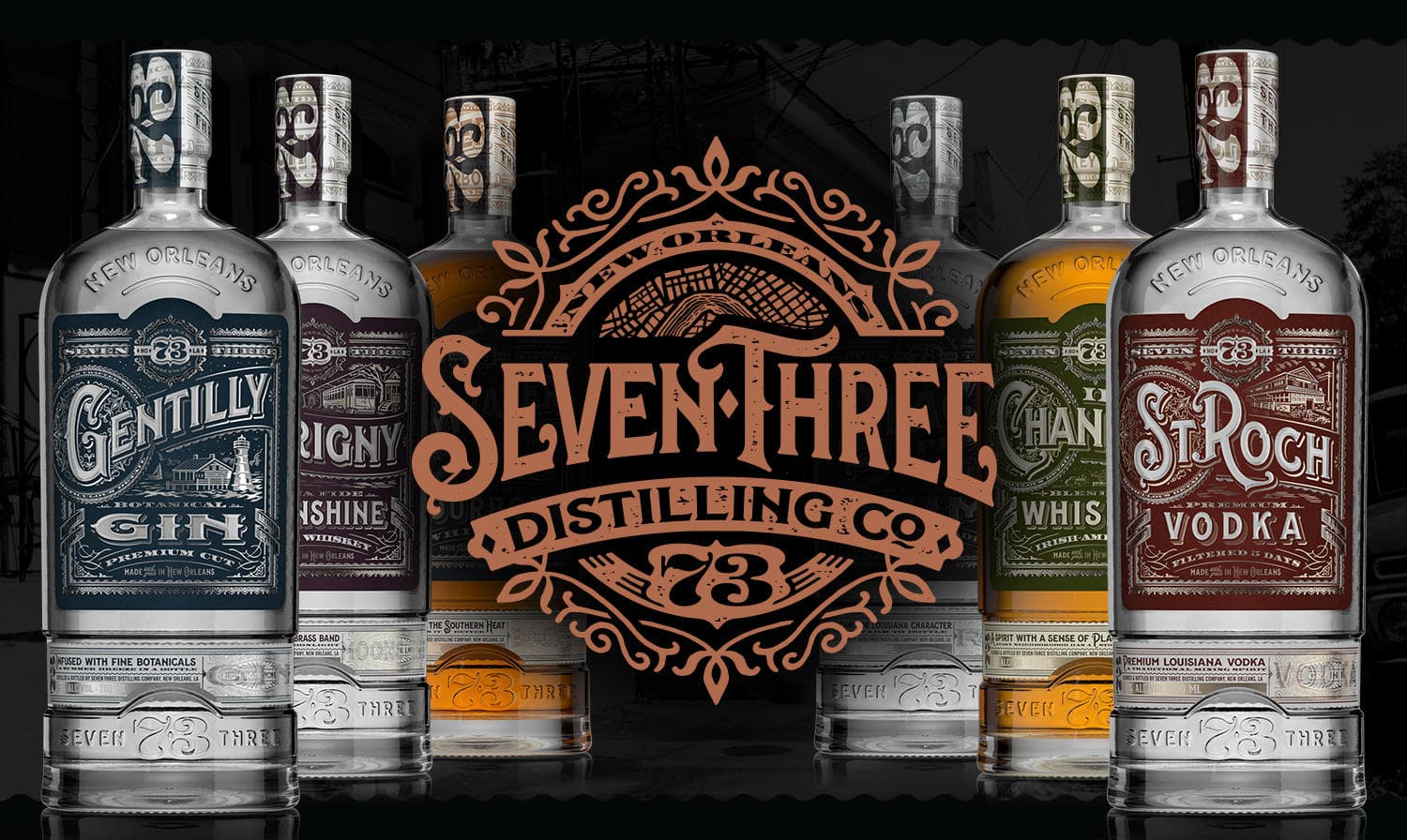 Assorted distillery bottles with branded logo backdrop, product display
