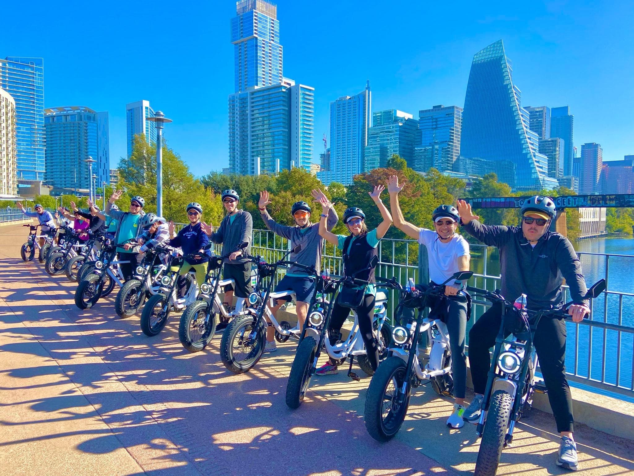 E-bike group riding along Austin skyline waterfront trail