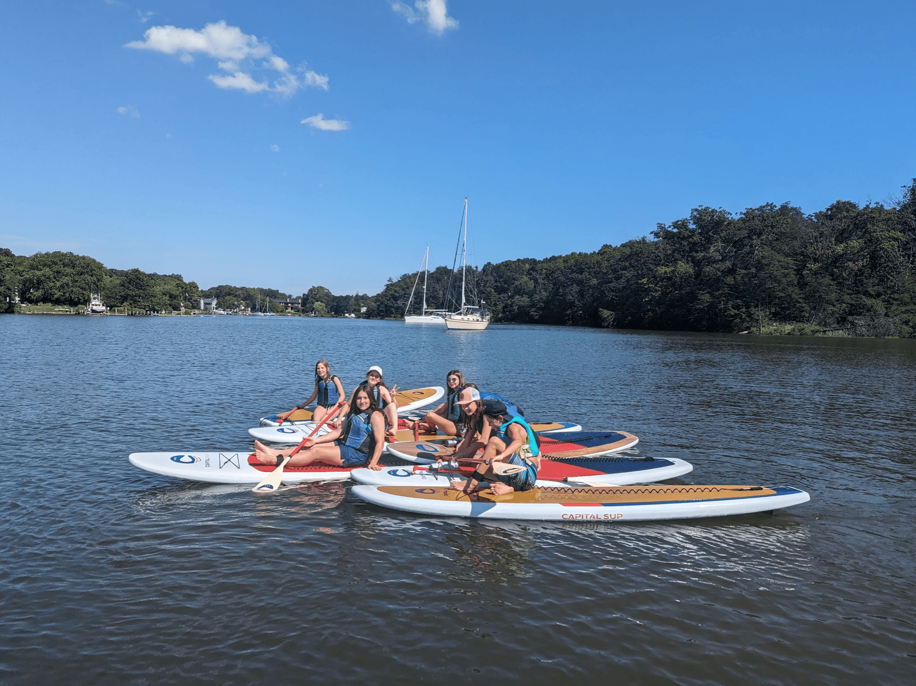 Evening waterfront paddleboarding near lit quay and boats