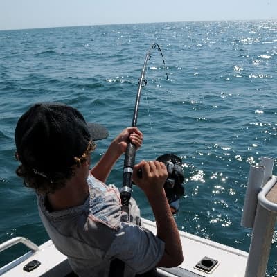 Deep sea fishing trip in Azores waters with angler reeling