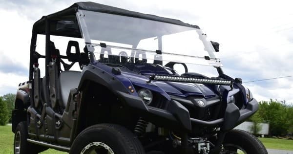 Side-by-side UTV on grassy trail showcasing group off-road tours