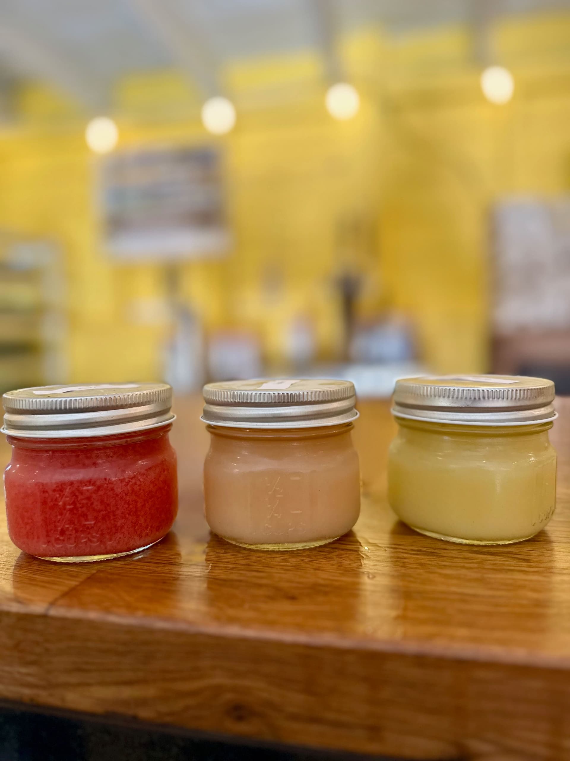 Small-batch jam tasting jars on farm shop counter at Sweetland Orchard