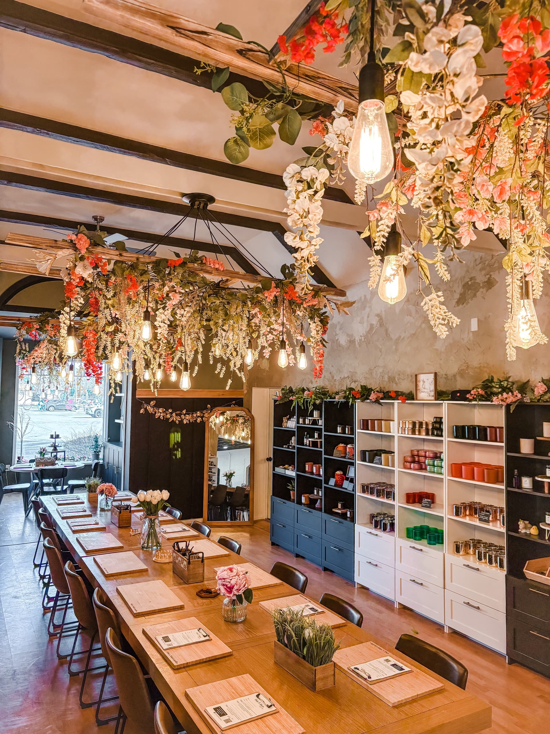 Decorated candle studio dining table with hanging floral lighting