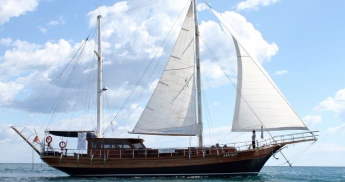 Two-masted gulet sailing on calm Mediterranean waters off Puglia