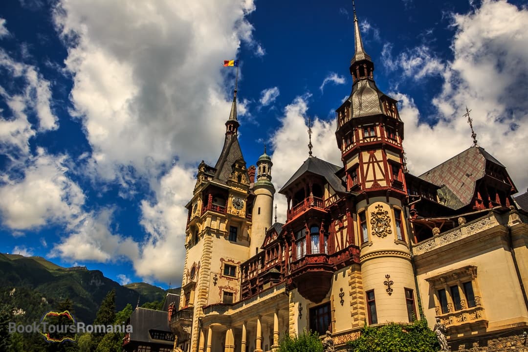 Peles castle facade under dramatic sky in Romania