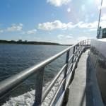 Ocean pier walkway with horizon and railing, coastal view