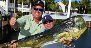 Charter anglers posing with trophy mahi at Key Largo marina