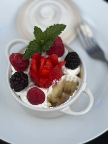 Mixed berry dessert in ramekin topped with fresh mint