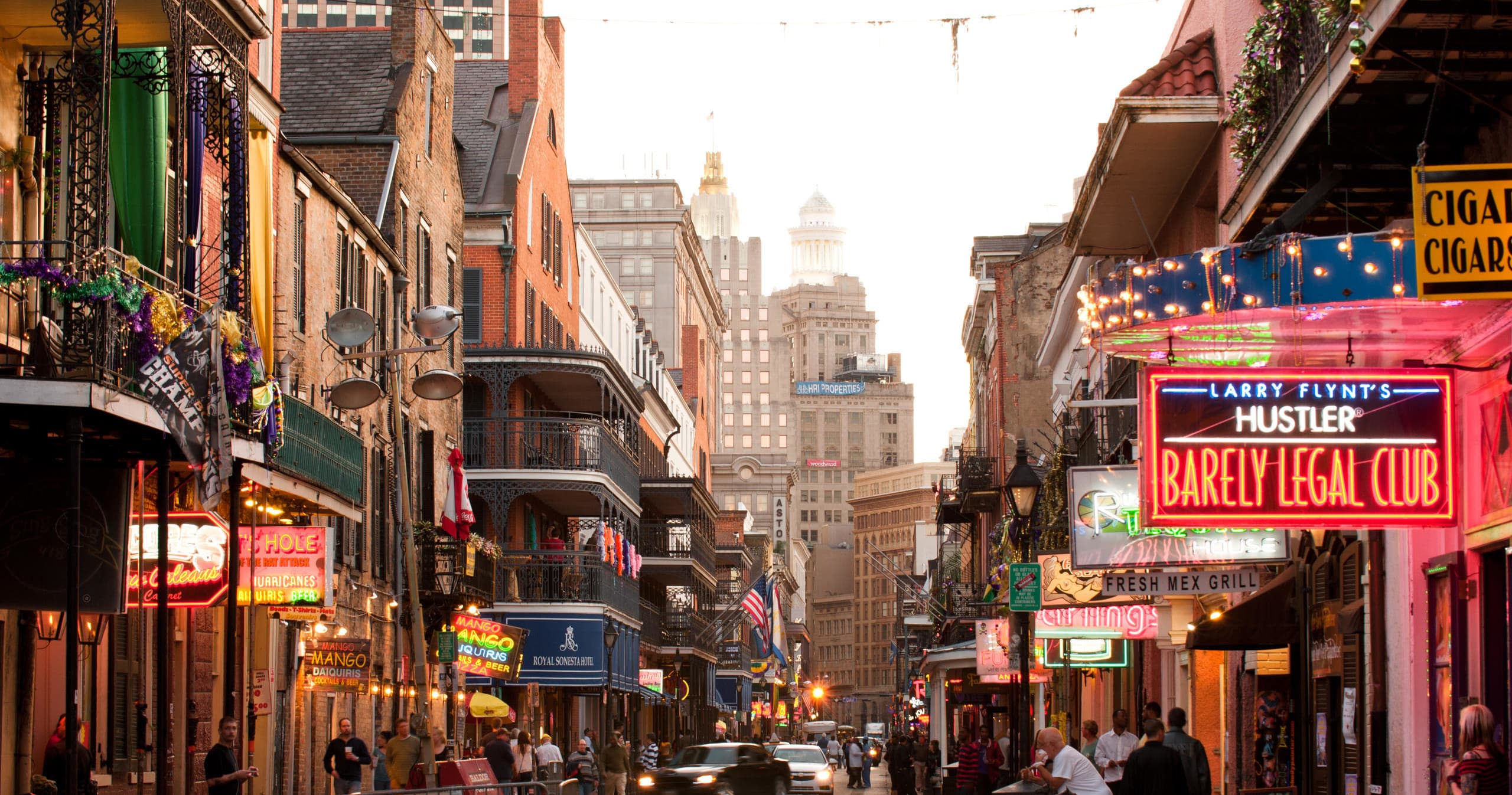 Nighttime Bourbon Street walking tour with neon signs and crowd