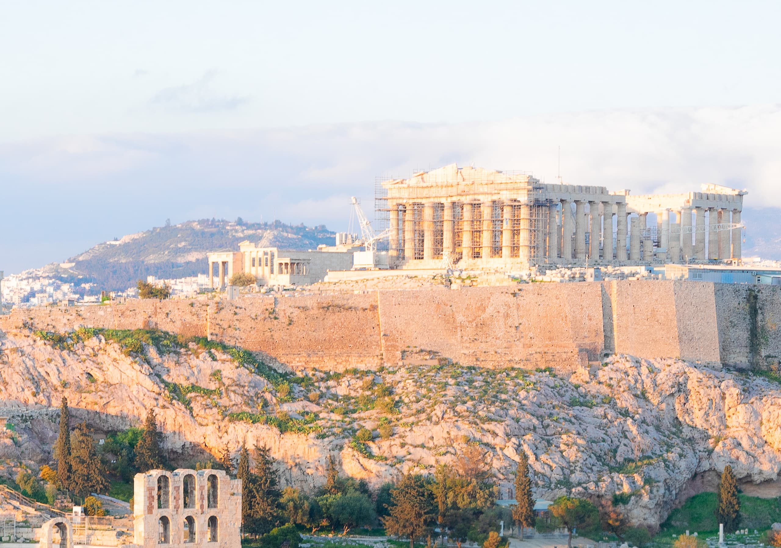 Ancient Acropolis hillscape in Athens bathed in warm morning light