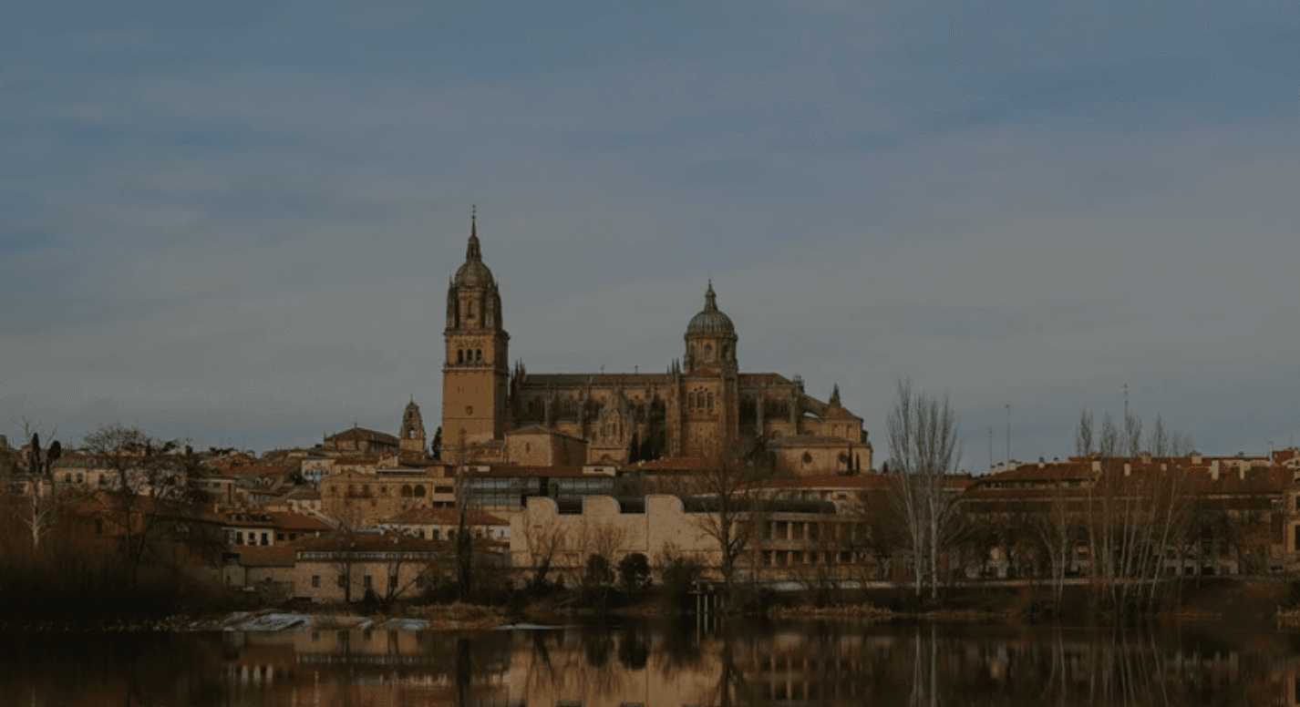 Riverfront cathedral skyline reflecting on river, historic city tour