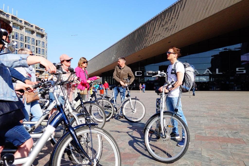 Cycling tour group outside Rotterdam Central, preparing for city ride