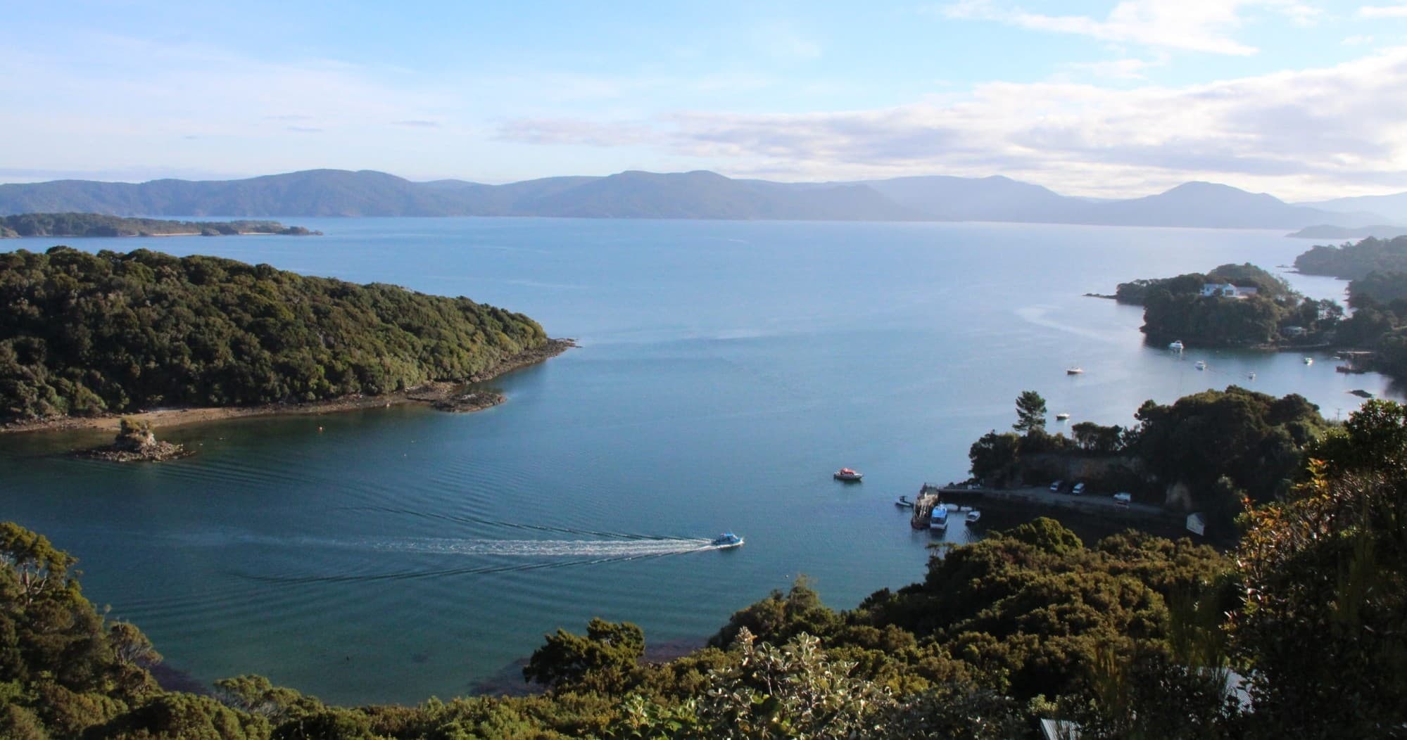 Panoramic coastal inlet view with islands and calm blue sea