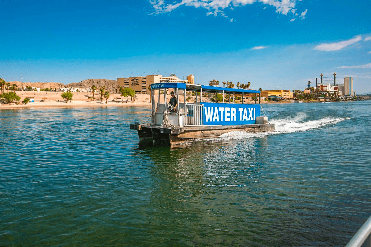 River water taxi approaching shore past clear green river waters