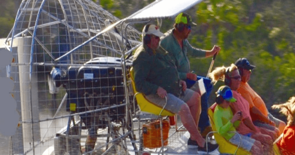 Close-up of airboat passengers enjoying guided swamp tour