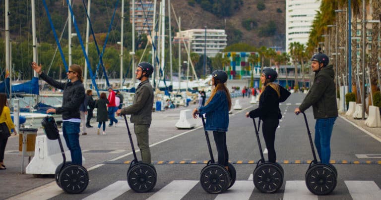 Segway riders crossing marina promenade in Malaga