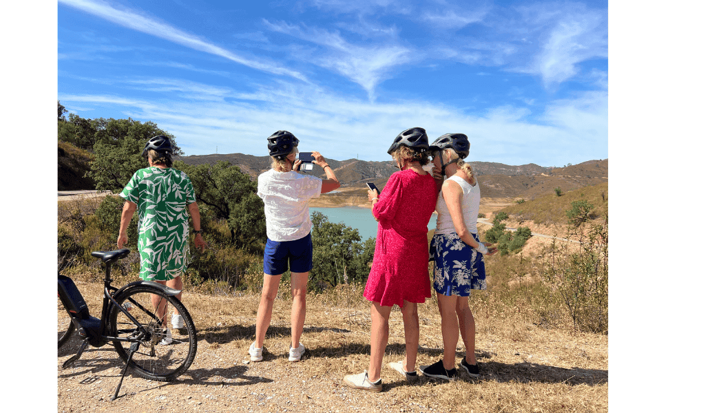 Cyclists admiring coastal Algarve vista during guided bike tour
