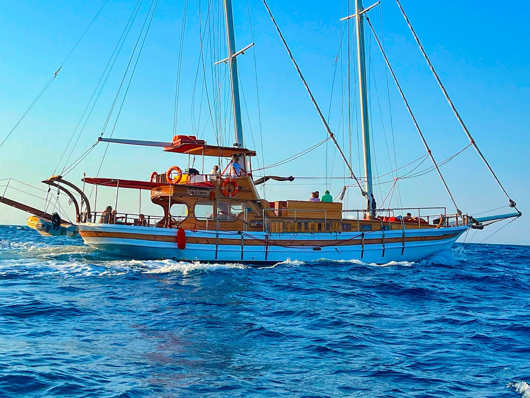 Traditional gulet sailing across vibrant Ionian Sea, open horizon