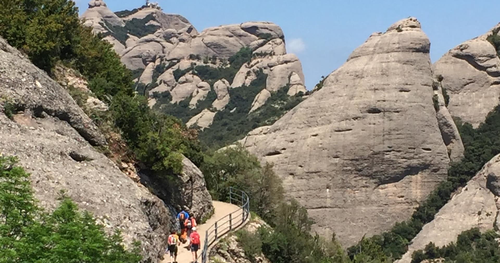 Trail winding through Montserrat's dramatic rock formations on day hike