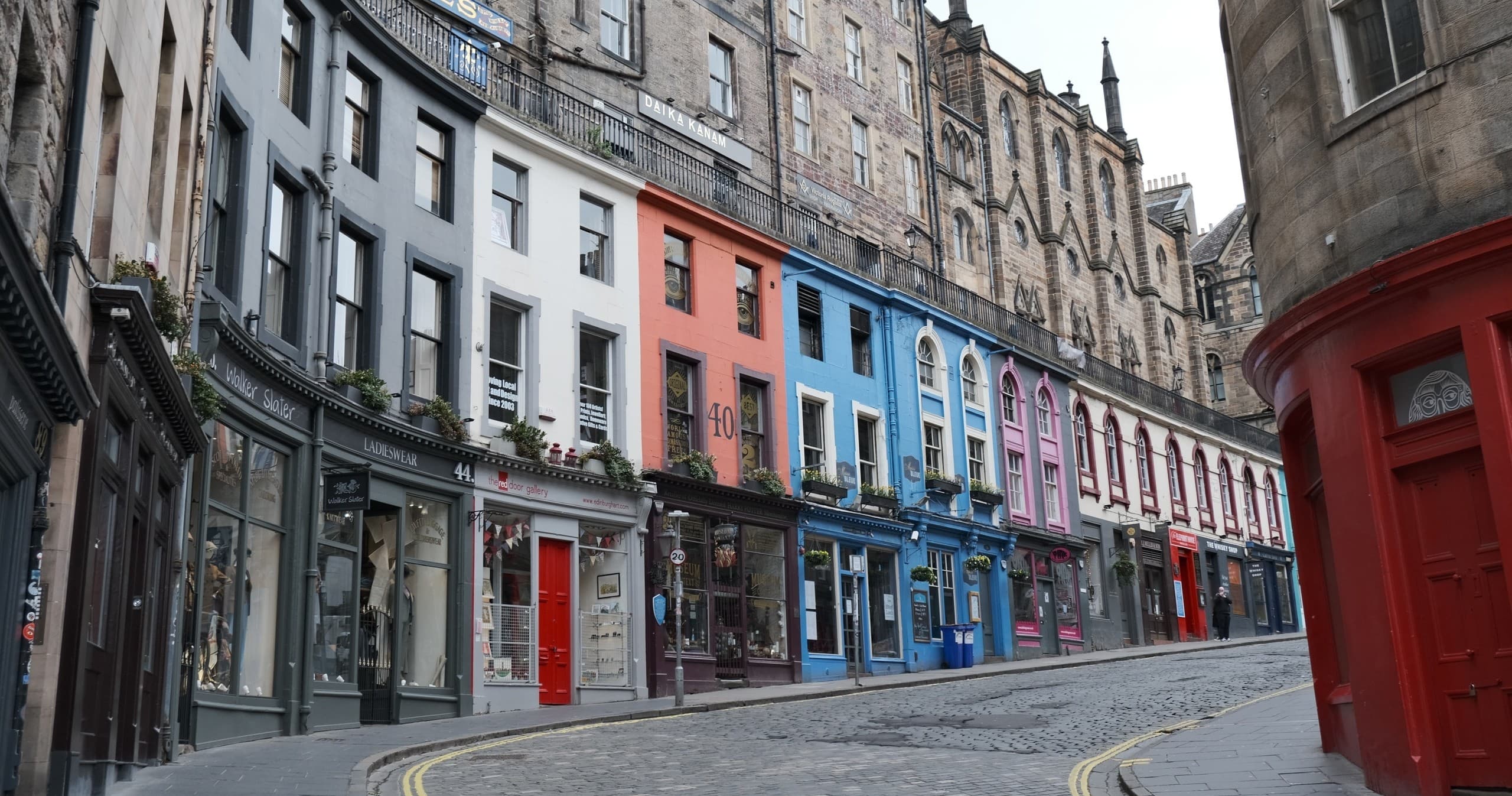 Curved colorful historic street for walking tours in Edinburgh Old Town