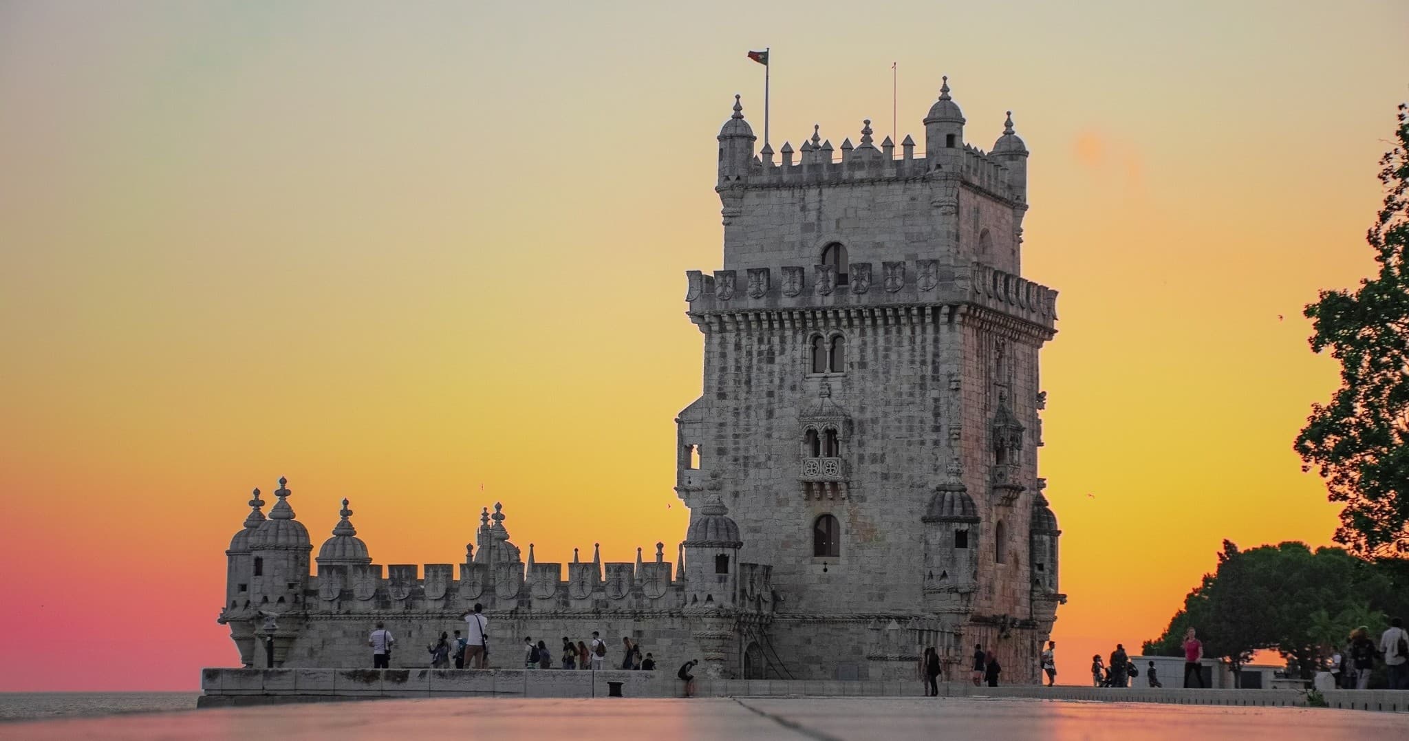 Belem Tower silhouetted at sunset on Lisbon waterfront