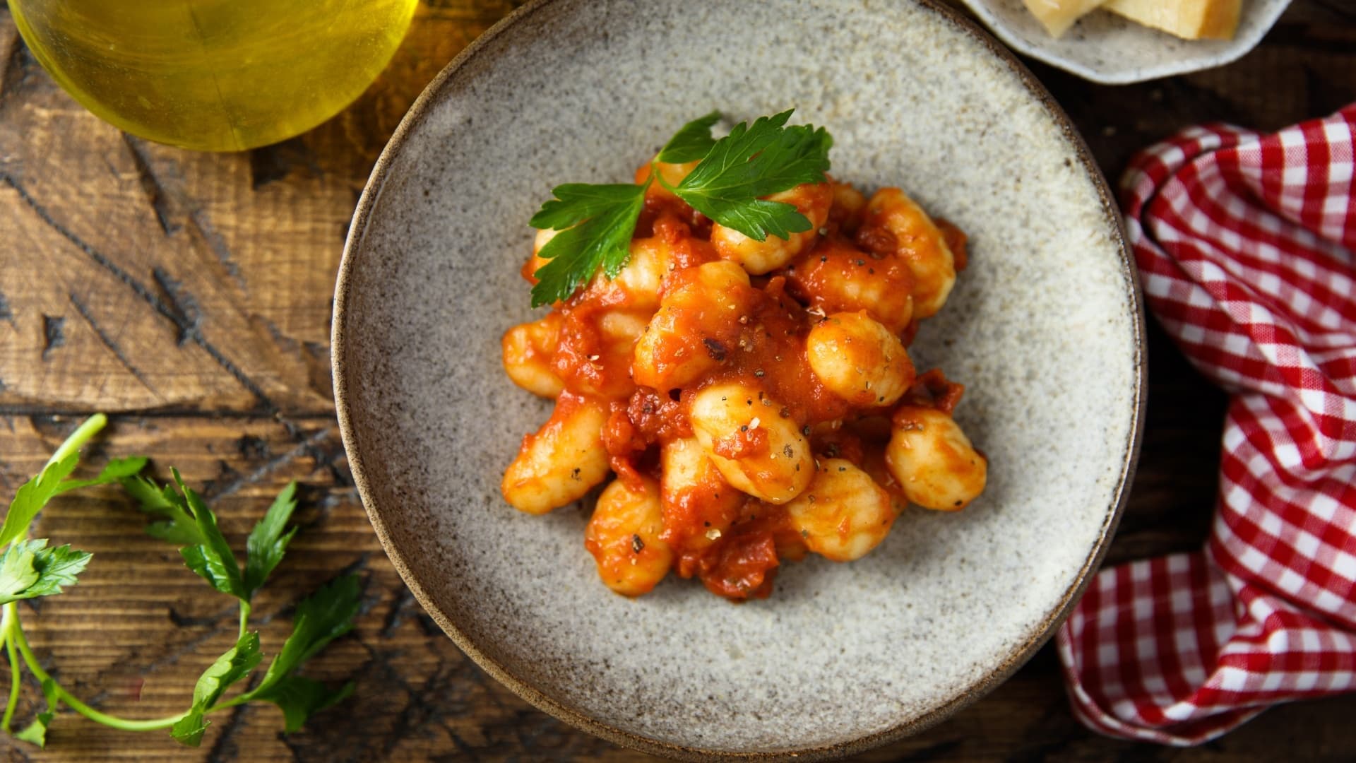 Pan-seared gnocchi in tomato sauce served in bowl, dinner