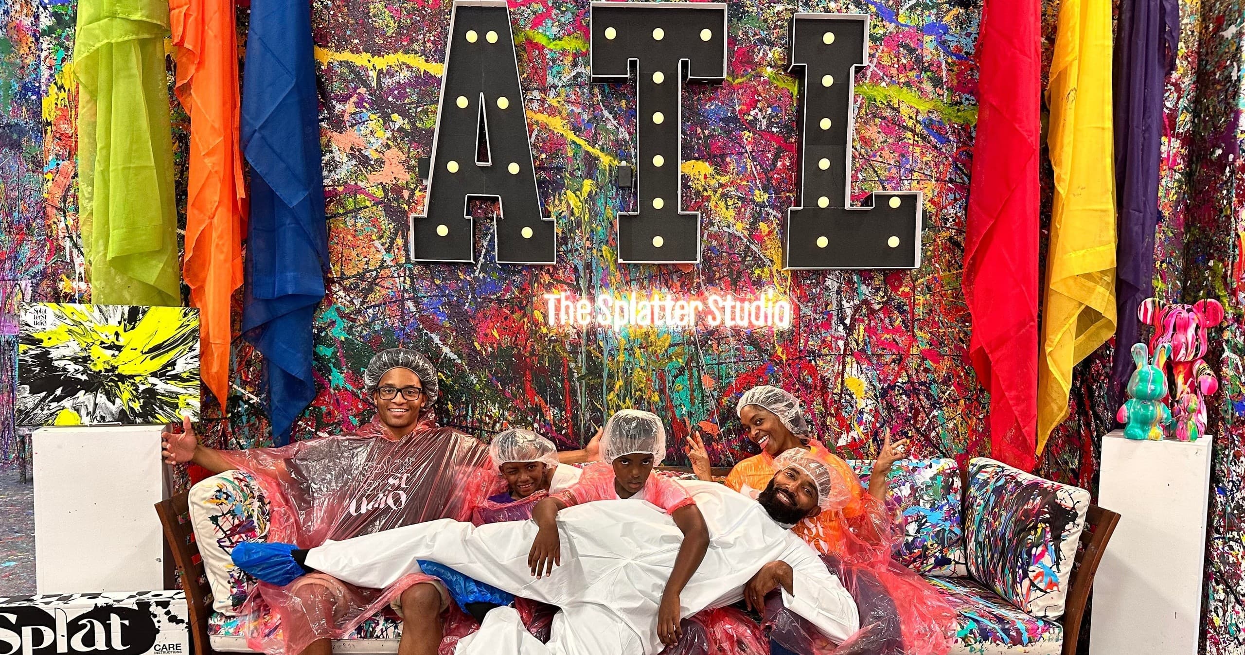 Colorful group relaxing in vibrant indoor splatter studio