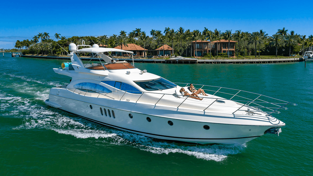 Elegant motor yacht slicing emerald water by palm-lined island