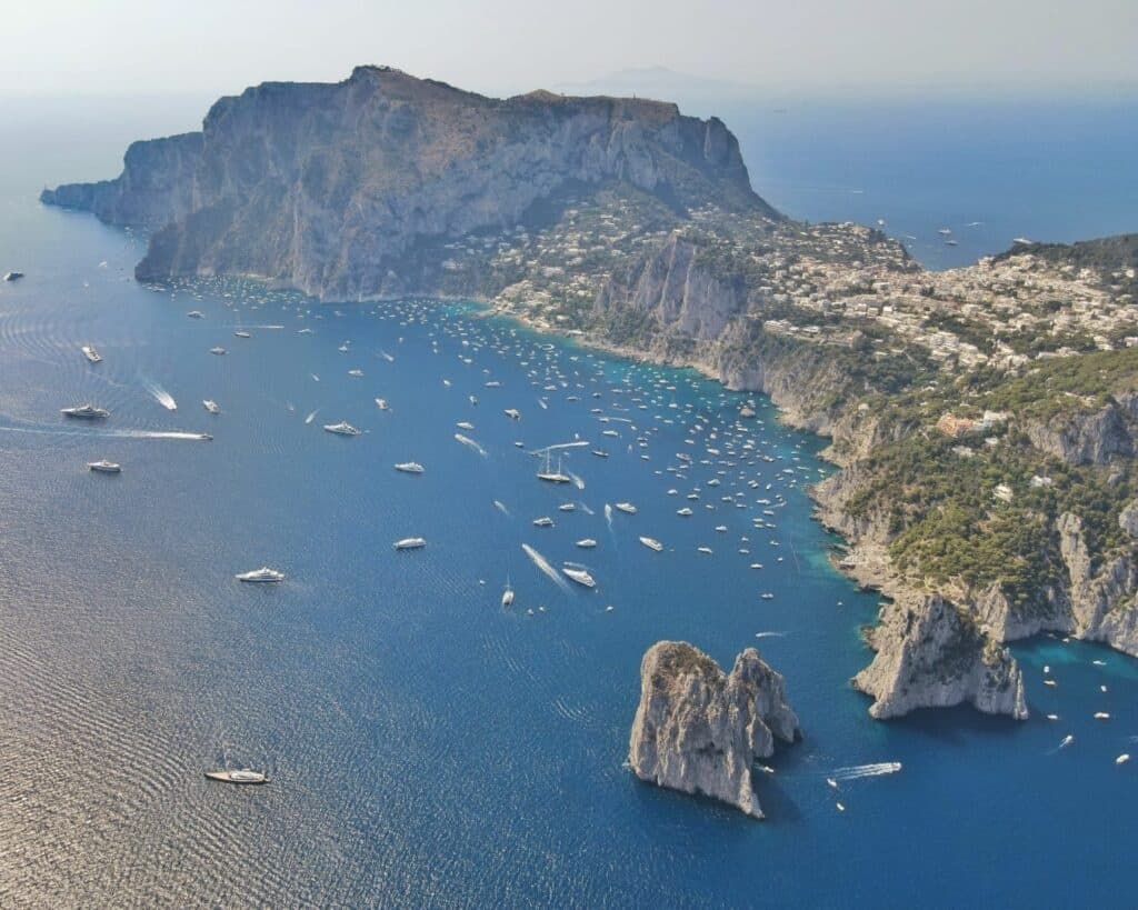Aerial view of Capri bay crowded with yachts on boat tour