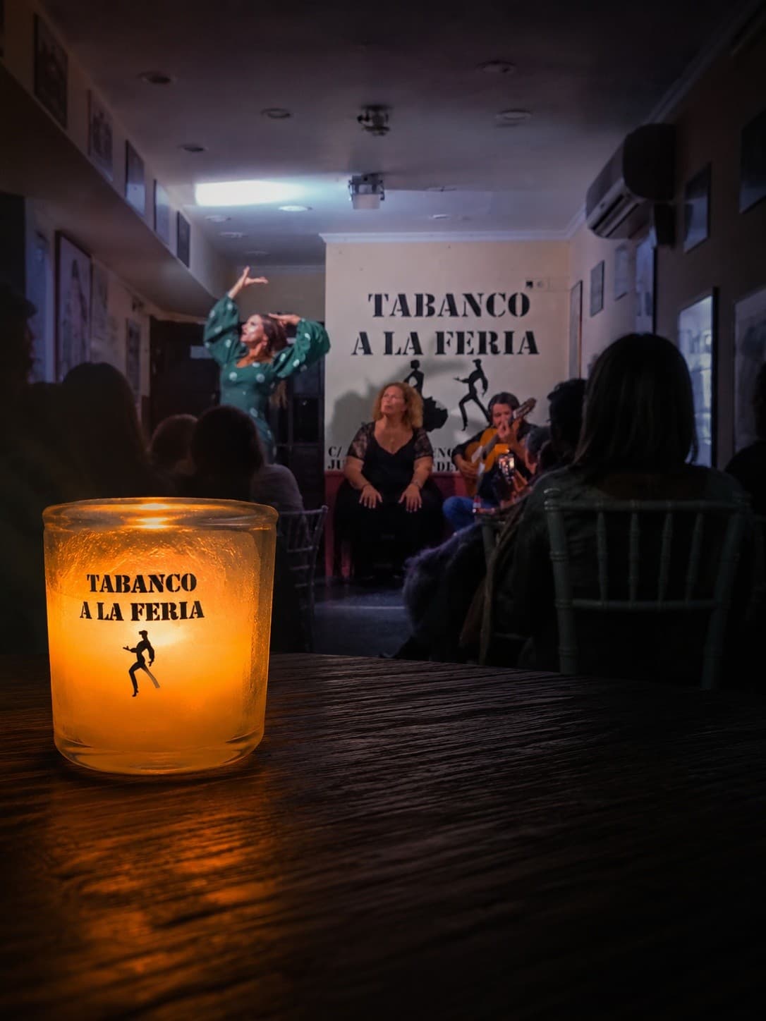 Candlelit tavern scene with flamenco performance and audience tables