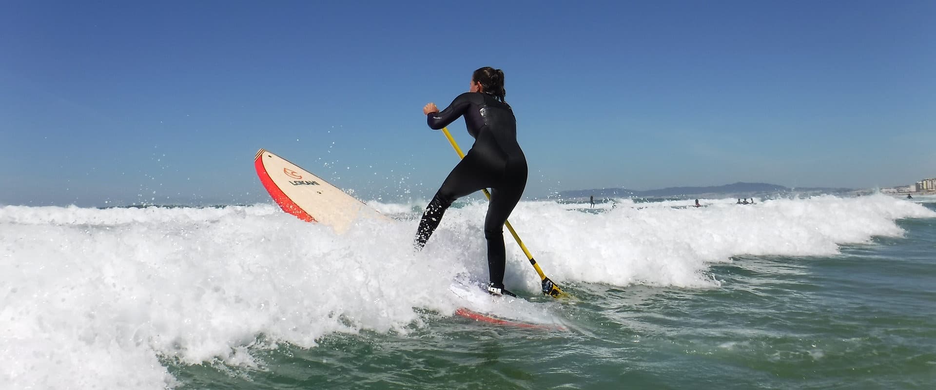 Surfer carving a wave on a shortboard in clear ocean surf