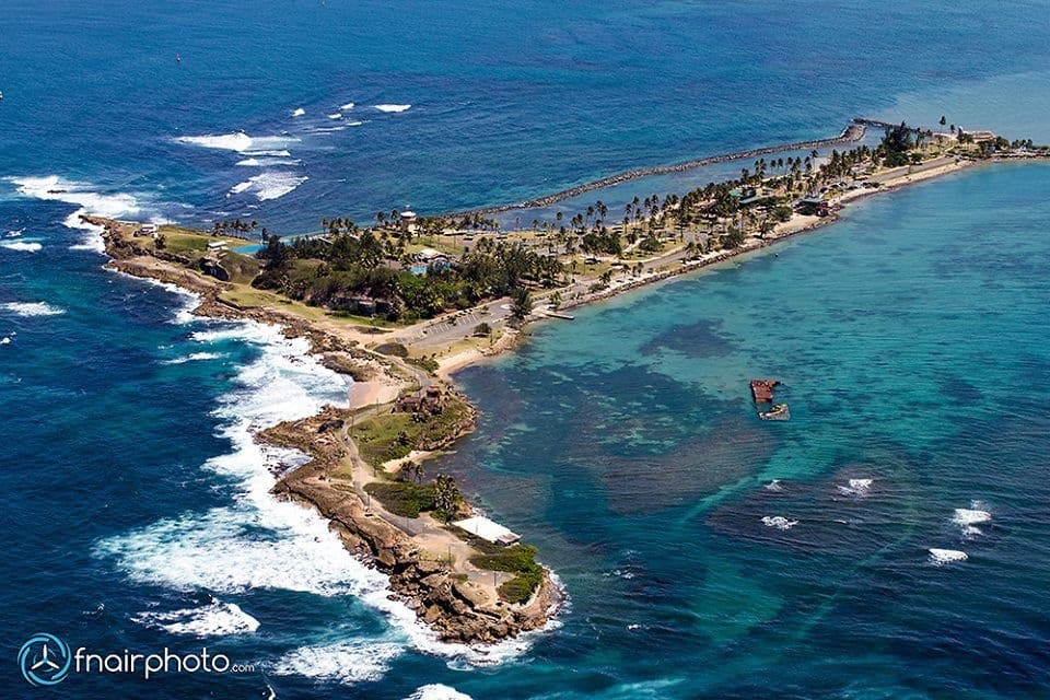 Aerial view of rocky Caribbean coastline and turquoise sea