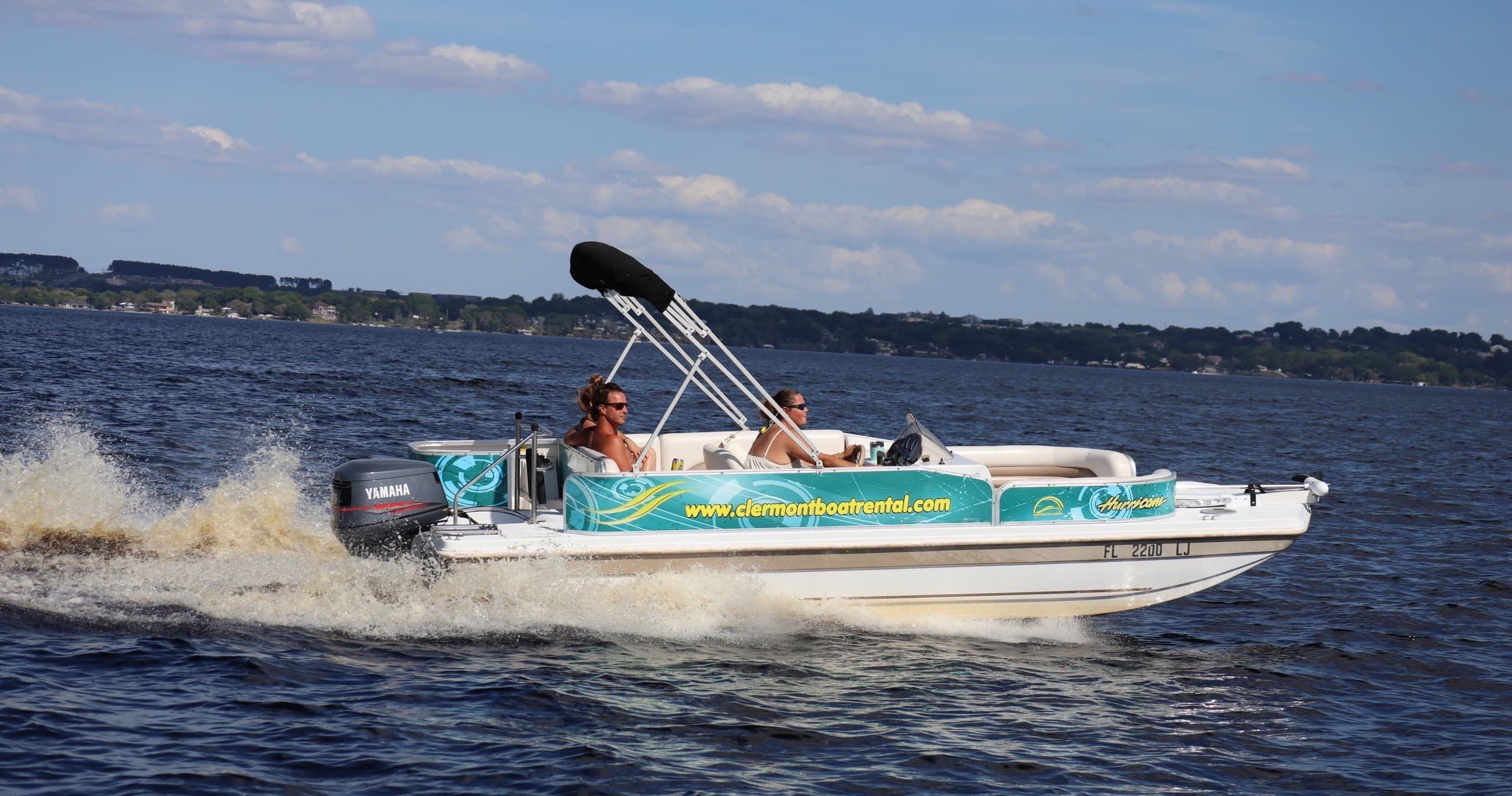 Pontoon boat speeding on Clermont Lake waters with passengers