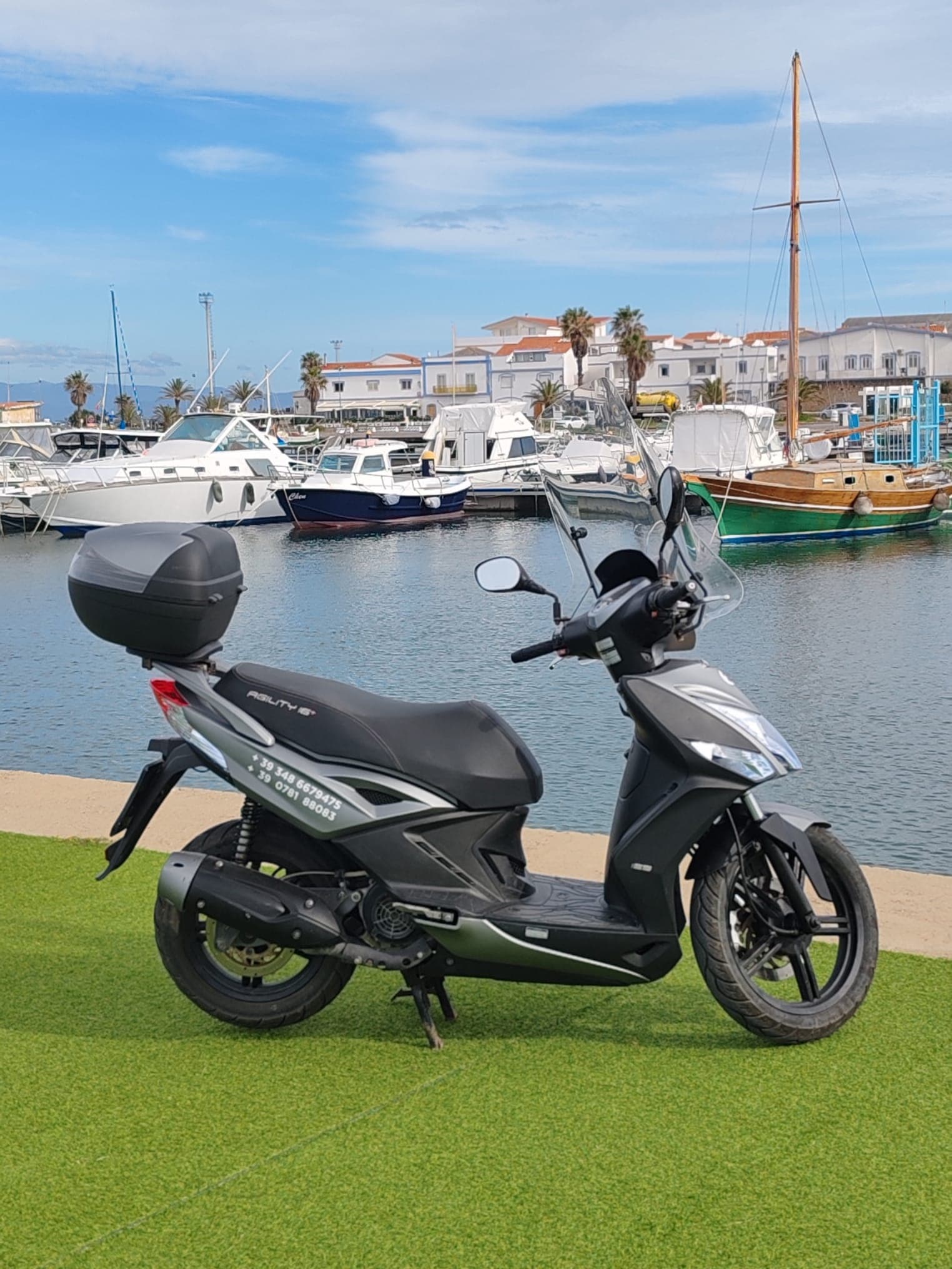 Urban scooter parked by marina docks for coastal rentals