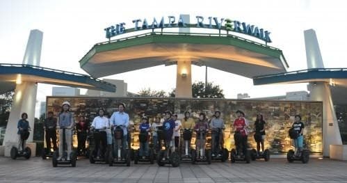 Group on Segway tour under Tampa Riverwalk arch at waterfront
